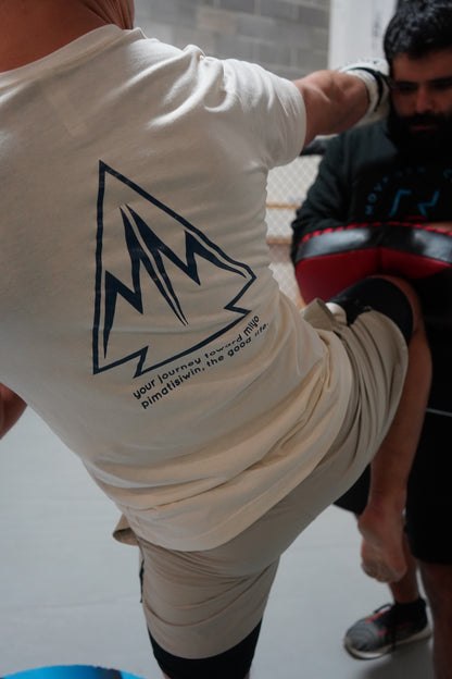 Two men boxing. One is wearing the Movement T-shirt in Natural with the back showing. The other is wearinga the Collective Hoodie with the front showing